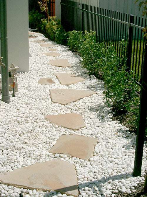 natural beach pebbles ivory install with hexagon pavers
